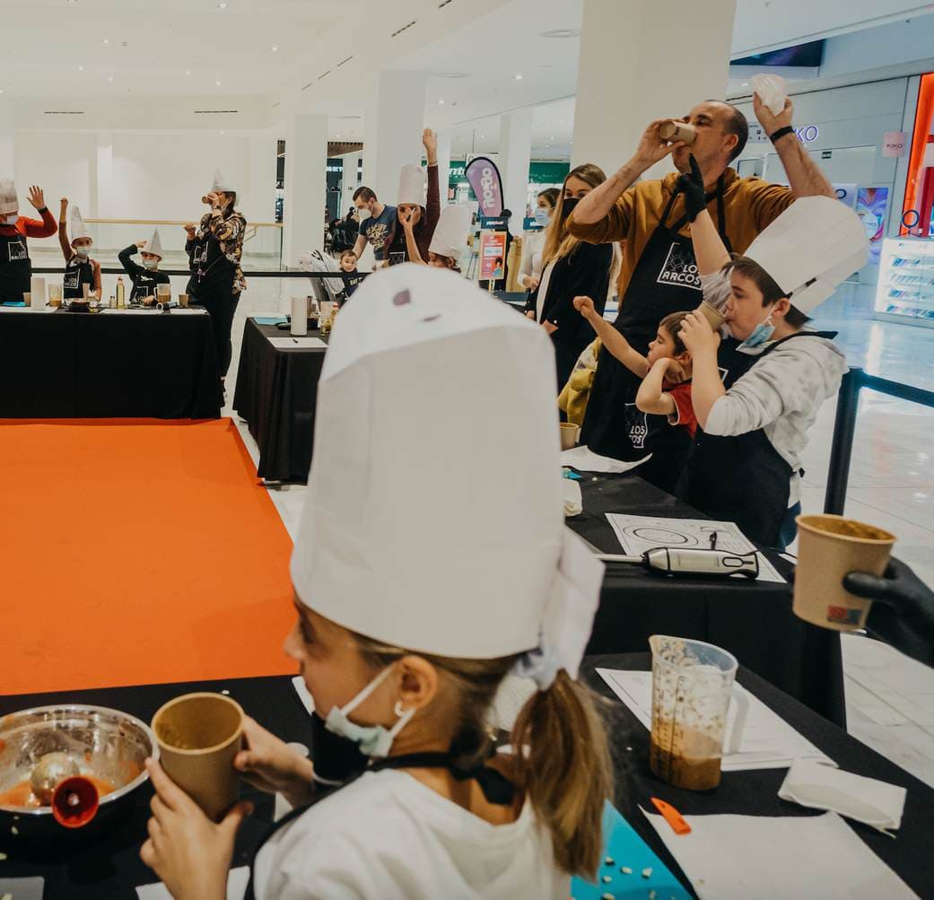 Niños con gorro de cocinero en un taller de alimentación infantil de La Habitación Saludable